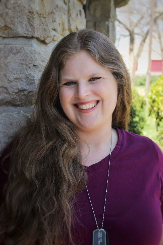 Timmons Chapel, a little medieval style chapel on the Pittsburg State University campus, makes a fitting backdrop for Dana Michael, who earned an M.A. in history from the school.