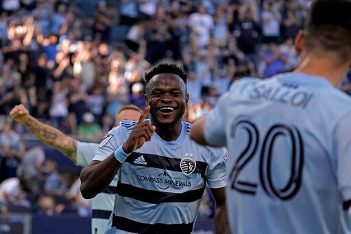 Sporting Kansas City midfielder William Agada celebrates after scoring a goal during the first half of an MLS soccer match against the Seattle Sounders Sunday, Oct. 2, 2022, in Kansas City, Kan. (AP Photo/Charlie Riedel)