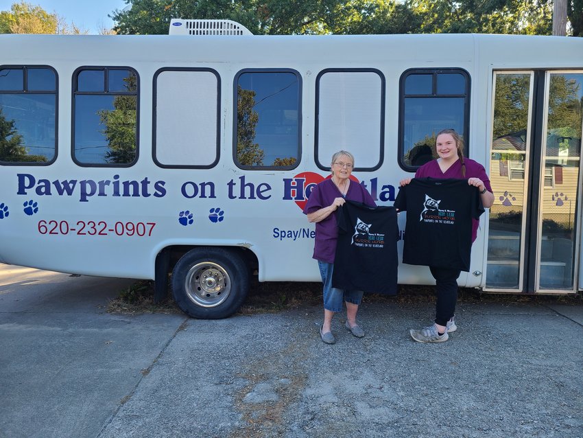 Hiss less, purr more! Dr. Laura Morland, left, and veterinarian technician Kaylee Harper show off new t-shirts available for $10 at Pawprints on the Heartland.