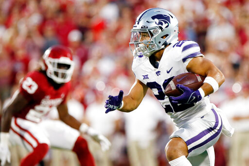 Kansas State running back Deuce Vaughn (22) carries the ball against Oklahoma in the first half of an NCAA college football game, Saturday, Sept. 24, 2022, in Norman, Okla. (AP Photo/Nate Billings)