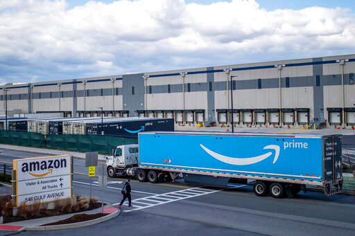 FILE - A truck arrives at the Amazon warehouse facility, in the Staten Island borough of New York, April 1, 2022. Amazon will hire 150,000 full-time, part-time and seasonal employees across its warehouses ahead of the holiday season.  The announcement, made Thursday, Oct. 6, shows the e-commerce behemoth is taking a less conservative approach to its holiday planning than Walmart.   (AP Photo/Eduardo Munoz Alvarez, File)