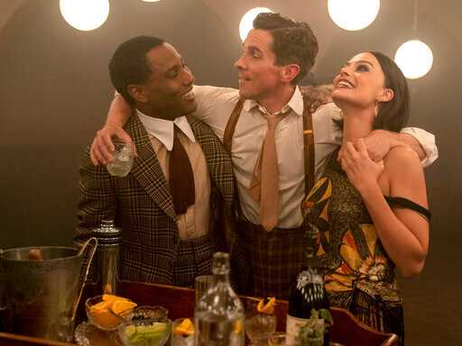 This image released by 20th Century Studios shows, from left, John David Washington, Christian Bale and Margot Robbie in a scene from &quot;Amsterdam.&quot; (Merie Weismiller Wallace/20th Century Studios via AP)