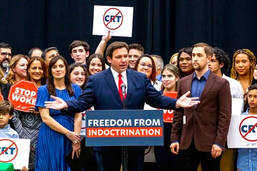 FILE - Florida Gov. Ron DeSantis addresses the crowd before publicly signing HB7, &quot;individual freedom,&quot; also dubbed the &quot;Stop Woke&quot; bill during a news conference at Mater Academy Charter Middle/High School in Hialeah Gardens, Fla., on Friday, April 22, 2022. As Republicans and Democrats fight for control of Congress this fall, a growing collection of conservative political action groups is targeting its efforts closer to home: at local school boards. DeSantis endorsed a slate of school board candidates, putting his weight behind conservatives who share his opposition to lessons on sexuality and what he deems critical race theory. (Daniel A. Varela/Miami Herald via AP, File)