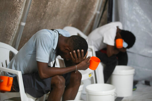 Patients with cholera symptoms sit in an observation center at a cholera clinic run by Doctors Without Borders in Port-au-Prince, Haiti, Friday, Oct. 7, 2022. (AP Photo/Odelyn Joseph)