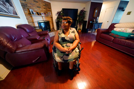 India Scott sits in the living room of her home in New Orleans, Monday, Oct. 10, 2022. Activists, advocates, researchers and people living with disabilities say not enough is being done to include disabled people in climate action planning and policy, or disaster relief and recovery efforts. (AP Photo/Gerald Herbert)