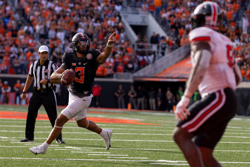 Oklahoma State's quarterback Spencer Sanders (3) rolls out of the pocket during the second half of an NCAA college football game against Texas Tech in Stillwater, Okla., Saturday, Oct. 8, 2022. (AP Photo/Mitch Alcala)