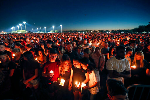 FILE - People attend a candlelight vigil for the victims of the shooting at Marjory Stoneman Douglas High School in Parkland, Fla., on Feb. 15, 2018. A jury on Thursday, Oct. 13, 2022, has recommended a sentence of life without parole for Nikolas Cruz, attacker in the 2018 shooting massacre that left 17 people dead at the Florida high school. (AP Photo/Gerald Herbert, File)