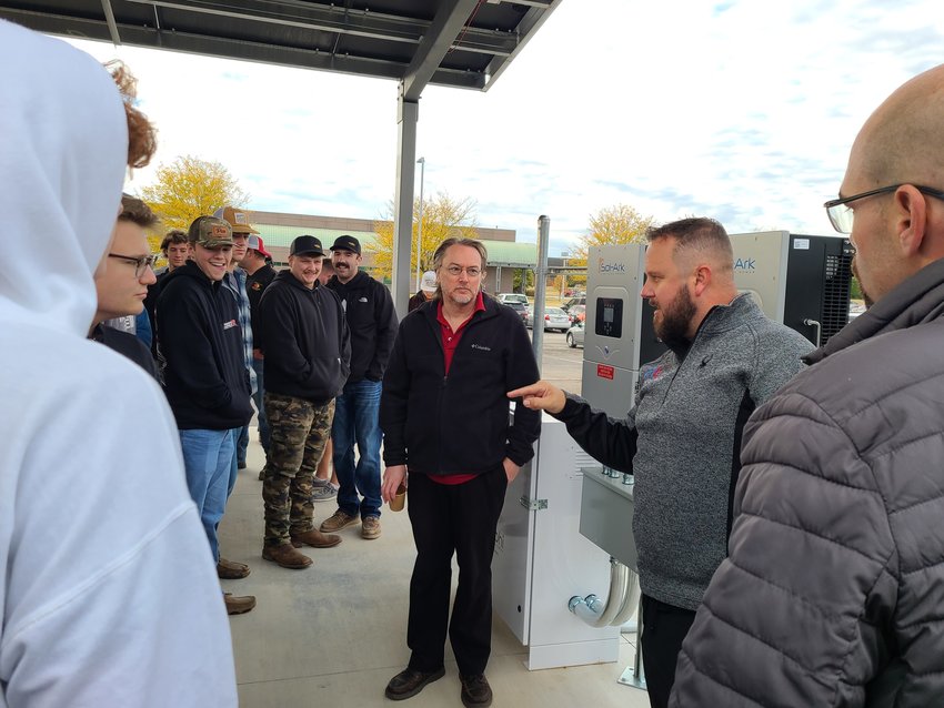 Owner of Alternative Electric Matt Pascal explains to a group of Pittsburg State University students how the new solar canopy behind the Kansas Technology Center draws and stores its power during a ribbon cutting event on Thursday morning.