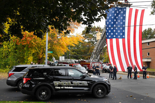 FILE - Police officers from Bristol, Conn. gather with other towns at the scene where two police officers killed, Thursday, Oct. 13, 2022, in Bristol, Conn. The deaths of two Connecticut police officers and the wounding of a third during an especially violent week for police across the U.S. fit into a grim pattern, law enforcement experts say. Even as the number of officers has dropped in the past two years, the number being targeted and killed has risen. (AP Photo/Jessica Hill, File)