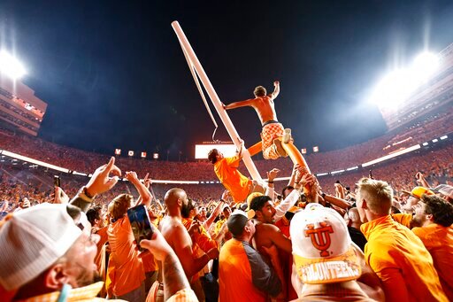 Tennessee fans tear down the goal post after defeating Alabama 52-49 in an NCAA college football game Saturday, Oct. 15, 2022, in Knoxville, Tenn. (AP Photo/Wade Payne)
