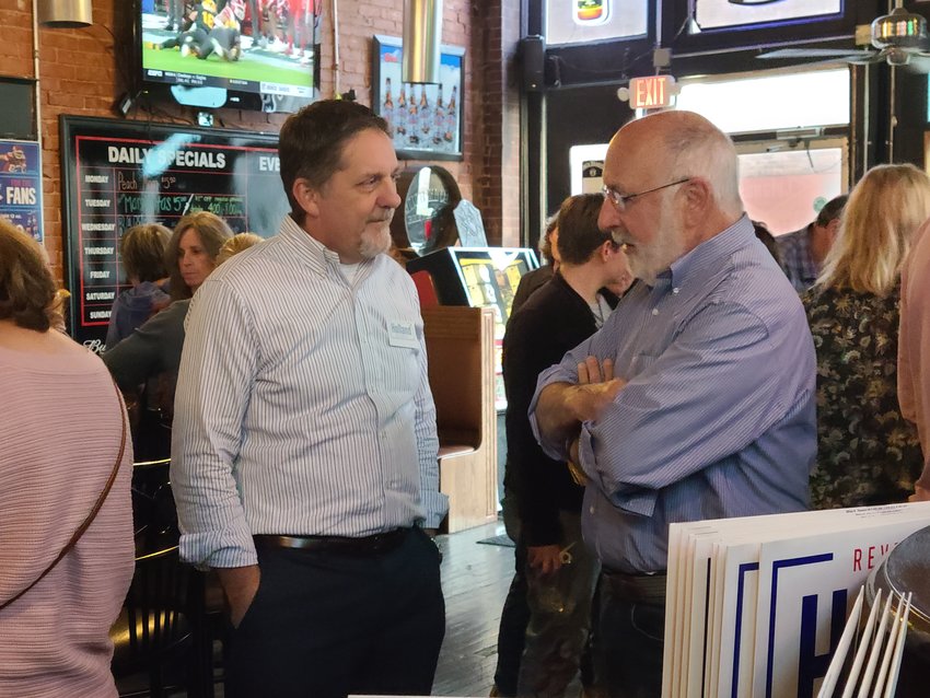 Tom Edminster, right, talks to Rev. Mark Holland about his campaign at the &ldquo;Save the Vote&rdquo; Democratic event on Friday at TJ Lelands.