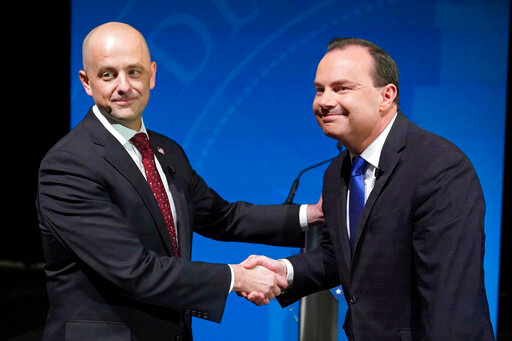 Utah Republican Sen. Mike Lee, right, and his independent challenger Evan McMullin shake hands before their televised debate, Monday, Oct. 17, 2022, in Orem, Utah, three weeks before Election Day. The debate will be the only time the candidates appear together in the lead-up to next month's midterm elections. (AP Photo/Rick Bowmer)
