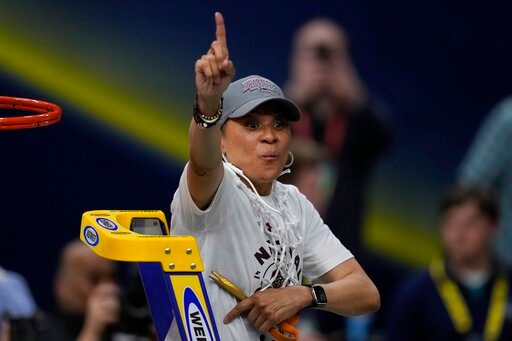 FILE - South Carolina head coach Dawn Staley cuts the net after a college basketball game in the final round of the Women's Final Four NCAA tournament against UConn, Sunday, April 3, 2022, in Minneapolis. Dawn Staley and South Carolina picked up right where they left off _ No. 1 in The Associated Press Top 25 women's basketball poll, Tuesday, Oct. 18. (AP Photo/Charlie Neibergall, File)