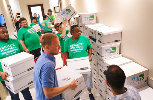 FILE - Oklahomans for Sensible Marijuana Laws delivers more than 164,000 signatures to the Office of the Secretary of State at the Oklahoma state Capitol in Oklahoma City, July 5, 2022. Oklahoma Gov. Kevin Stitt on Tuesday, Oct. 18, 2022, set a special statewide election for March 7 for voters to decide whether to legalize the recreational use of marijuana. (Doug Hoke/The Oklahoman via AP, File)