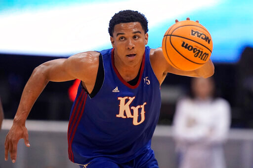 Kansas guard Kevin McCullar Jr. drives during Late Night in the Phog, the school's annual NCAA college basketball kickoff, at Allen Fieldhouse, Friday, Oct. 14, 2022, in Lawrence, Kan. (AP Photo/Charlie Riedel)