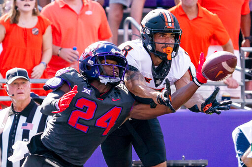TCU cornerback Josh Newton (24) deflects a pass intended for Oklahoma State wide receiver Braydon Johnson (8) during the first half of an NCAA college football game in Fort Worth, Texas, Saturday, Oct. 15, 2022. (AP Photo/Sam Hodde)