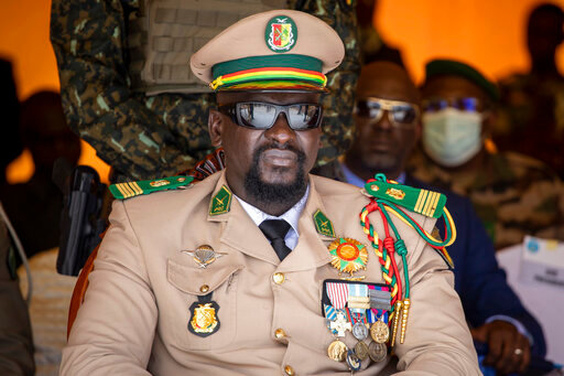 FILE - Guinea's junta leader Col. Mamady Doumbouya watches over an independence day military parade in Bamako, Mali on Sept. 22, 2022. The government led by Guinea's coup leader reached an agreement late Friday, Oct. 21, 2022 with West African regional mediators on a schedule for holding new elections a little over two years from now. (AP Photo, File)