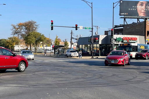 Tire marks from drifting can be seen in the intersection of Archer and Kedzie avenues, where a shooting occurred early Sunday, Oct 23, 2022. (David Struett/Chicago Sun-Times via AP)