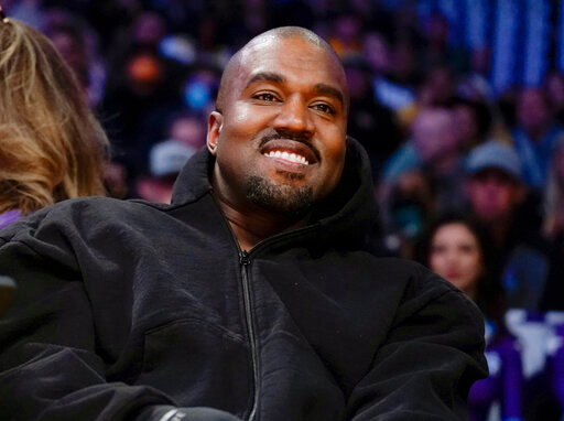 FILE - Kanye West watches the first half of an NBA basketball game between the Washington Wizards and the Los Angeles Lakers in Los Angeles, on March 11, 2022 A completed documentary about the rapper formerly known as Kanye West has been shelved amid his recent slew of antisemitic remarks.. (AP Photo/Ashley Landis, File)