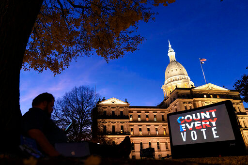 FILE - The phrase &quot;Count Every Vote&quot; is displayed on a large screen, organized by an advocacy group in front of the State Capitol on Nov. 6, 2020, in Lansing, Mich. As local election offices across the U.S. count millions of votes on election night, Nov. 8, 2022, they share the results with polling firms, which transmit them to viewers watching live on their devices. Along the way, humans reporting these results occasionally make errors, causing false vote counts to temporarily appear in TV news graphics. However, these small mistakes are not a sign of anything nefarious &mdash; and fortunately, quality control measures in election offices and polling firms ensure they happen rarely and get fixed quickly. (AP Photo/David Goldman, File)