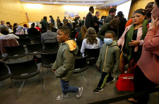 &quot;Virtual school is not the answer,&quot; said mother Cheryl Lane, right, who leaves a Hazelwood School Board meeting with her two sons, Aaron, 9, left, and Andrew, 7, Tuesday, Oct. 18, 2022, at the Hazelwood School District Learning Center in Florissant, Mo. The board announced elementary students will switch to virtual learning after radioactive waste was found at Jana Elementary School. &quot;My kids have been virtual since the start of the school year and they are not learning,&quot; said Lane. (Laurie Skrivan/St. Louis Post-Dispatch via AP)