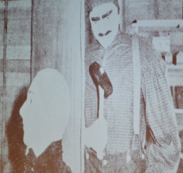 Panelists show a photo of the mannequins that were posed in the 1961 reconstructed cabin depicting young John Bender about to strike his victim.