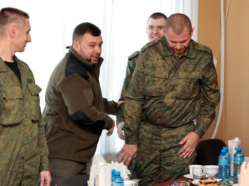 Denis Pushilin, leader of self-proclaimed Donetsk People&rsquo;s Republic, second left, meets with liberated soldiers during the exchange of servicemen of the Donetsk People&rsquo;s Republic who were imprisoned and the Lugansk People&rsquo;s Republic, in Amvrosiivka, Donetsk People&rsquo;s Republic, eastern Ukraine, Tuesday, Nov. 1, 2022. Russia and Ukraine on Saturday made an exchange of prisoners, which took place according to the formula &quot;50 to 50&quot;. (AP Photo/Alexei Alexandrov)