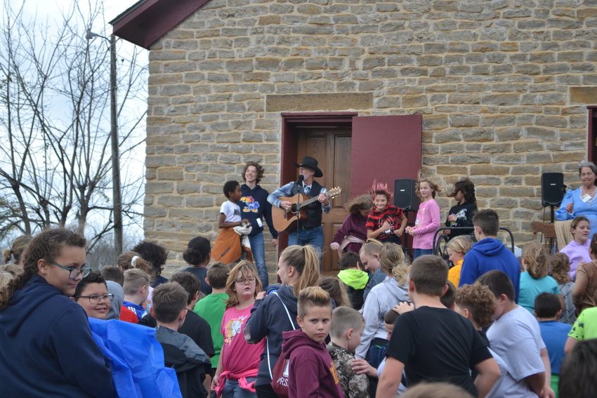 Welcome to Cato! Dan Duling leads the kids in a sing-a-long as buses arrive from around the area. Songs included &ldquo;Home on the Range,&rdquo; accompanied by the kids howling like coyotes, &ldquo;Bingo,&rdquo; and &ldquo;This Land Is Your Land.&rdquo;