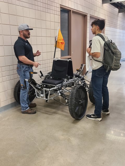 Matthew Long, left, shows student Jaydin Arroyos last year&rsquo;s design for NASA&rsquo;s Human Exploration Rover Challenge (HERC) at the Open House and Career Expo at the Pittsburg State University College of Technology on Friday. The open house was an opportunity for students to view demonstrations and learn about the programs the college has to offer. Over 700 students registered for the open house, with some coming from as far away as Illinois and Texas.