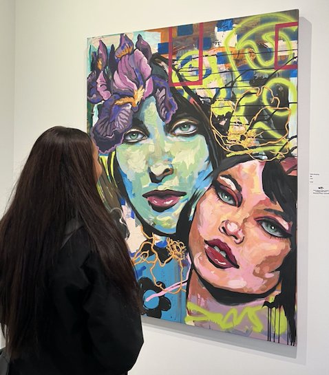 PSU junior Claire Bruening looks at her painting &ldquo;Oz,&rdquo; which won second place, hanging in the Cornell Complex of the Spiva Center for the Arts as part of the Joplin Regional Artists Coalition Emerging Artist Show.