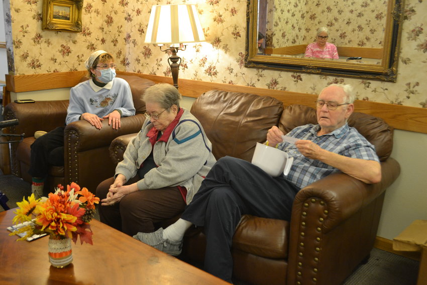 From left, PSU senior Jordan Eidson listens with Connie Wary as Danny Bitner reads a prompt during a storytelling activity at Guest Home Estates that Eidson organized for her social work project.