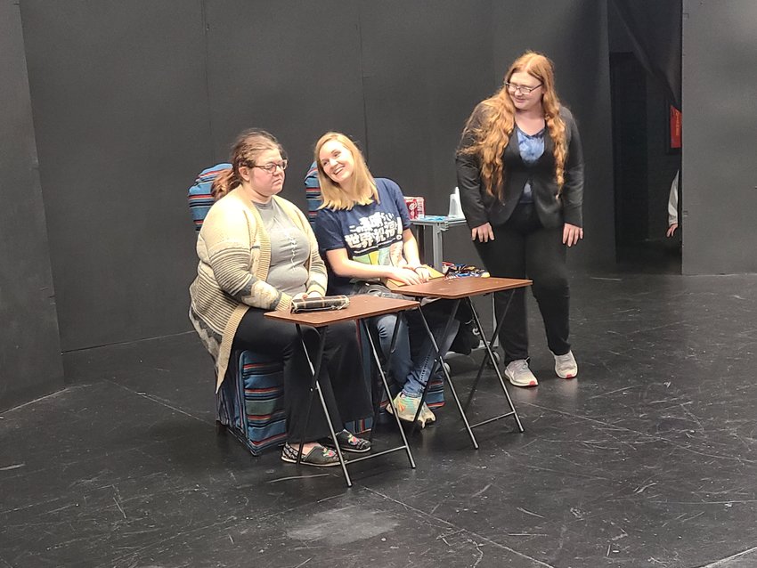 From left, Mariah Reynolds makes an irritated face at Emma Springer while Chantel Shaw asks what drinks they would like for the one-act play &ldquo;Relative Strangers.&rdquo;