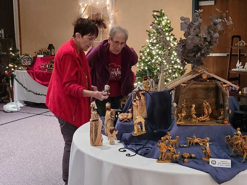 Vicki Gilson, left, and Terry Brannon work on completing the scavenger hunt amidst almost 300 nativities during the Nativity Festival at the local Church of Jesus Christ of Latter-day Saints on Saturday. The list of requirements for the scavenger hunt included finding the smallest nativity, tallest nativity, a donkey wearing a bell, a picture of Joseph holding Jesus, and many more. Attendees were also encouraged to write down their favorites, which Gilson and Brannon said they couldn&rsquo;t choose.
