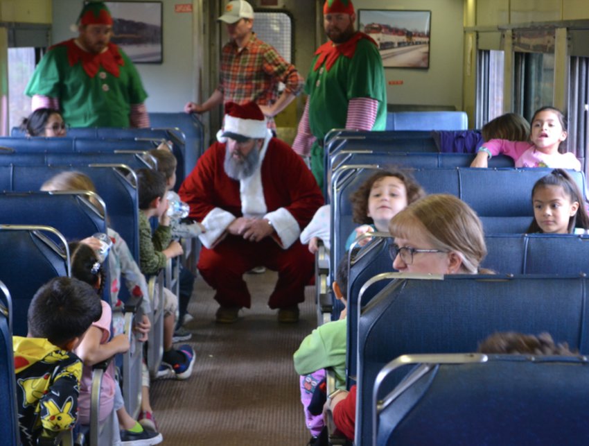Santa and his elves make a list of Christmas wishes from over 250 first grade students and teachers during an hour-long Holiday Express train ride Tuesday. The event was sponsored by Watco&rsquo;s SKOL Railroad and Heart of the Heartlands.&nbsp;