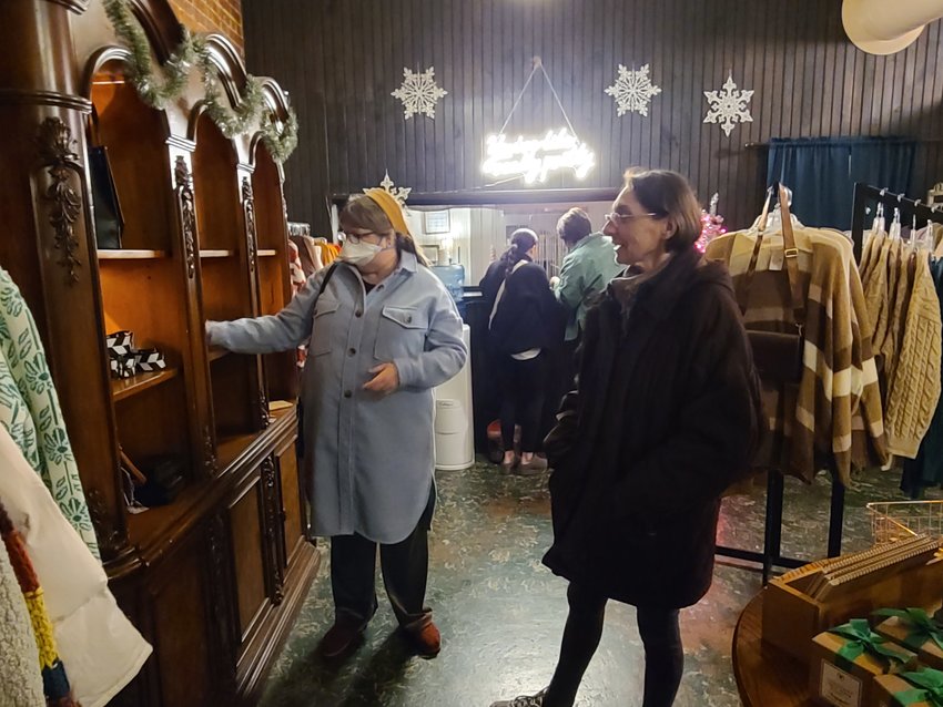 Laura Washburn, left, and Myriam Krepps browse Audacious Boutique during this week&rsquo;s Late Night Thursdays downtown event. To assist holiday shoppers, many stores are staying open until 7 p.m. on Thursdays through the month of December. As an added incentive, each store was given five vouchers for a commemorative ornament to hand out to the first five customers who shop after 5 p.m. Sydney Anselmi, owner of Audacious Boutique, had already handed out all her vouchers before 6 p.m.