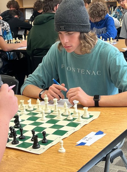 Nathan Troth, a freshman at Frontenac High School at the time, contemplates his next move at a chess tournament held in Cherryvale on Nov. 6, 2021.&nbsp;