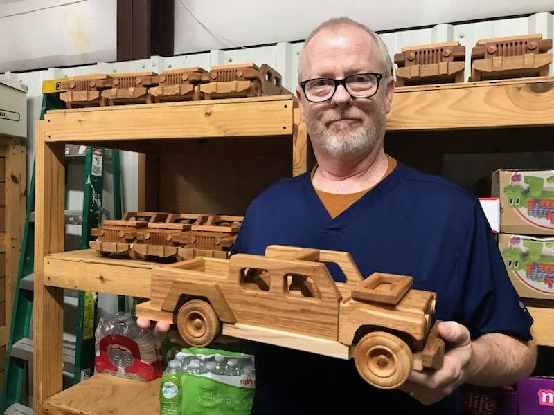Lawrence citizen Jay Morris shows this year&rsquo;s off-road vehicles he and a group of volunteers created from scraps of wood. Every year, Morris and his brother create 100 toys and donate them to Toys for Tots in several counties around the state.