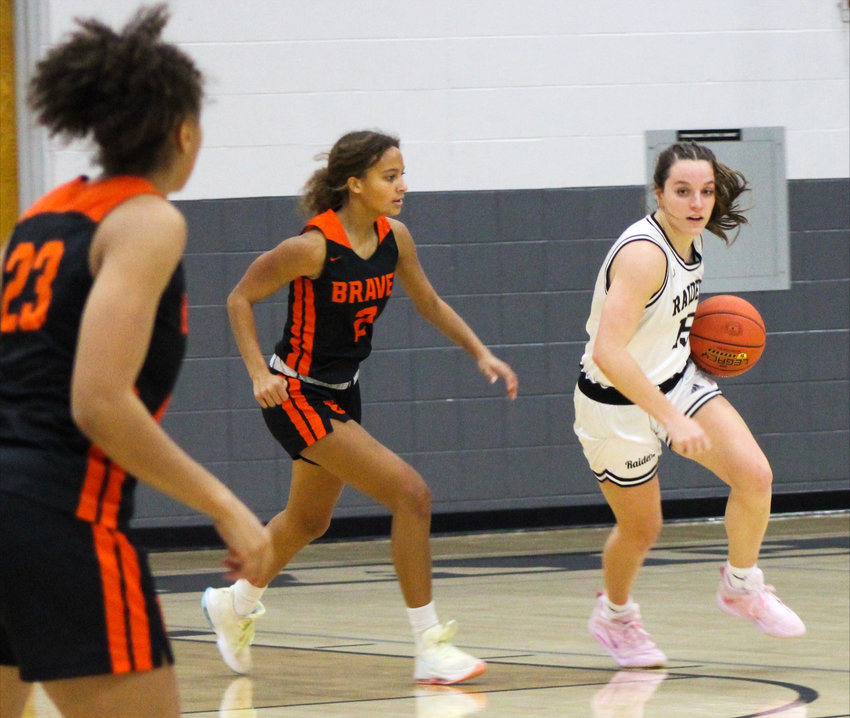 Frontenac senior forward Hattie Pyle dribbles past Bonner Springs defenders,  Pirsten Leslie (No. 2) and Mariyah Noel (No. 23). Pyle led all scorers with 23 points on Tuesday in the FHS gymnasium.