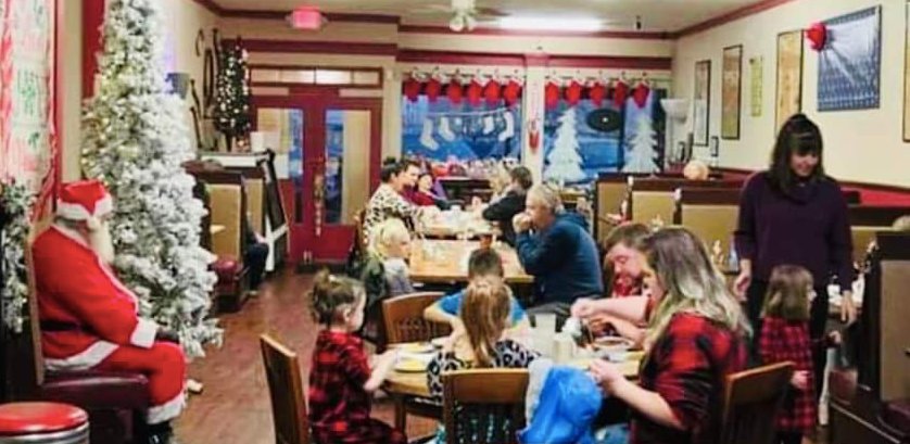 Children and their parents enjoy a free Breakfast with Santa at&nbsp;Girard&rsquo;s Eastside Diner on the Square on Tuesday morning. Each child received a present and an opportunity to visit with Santa.