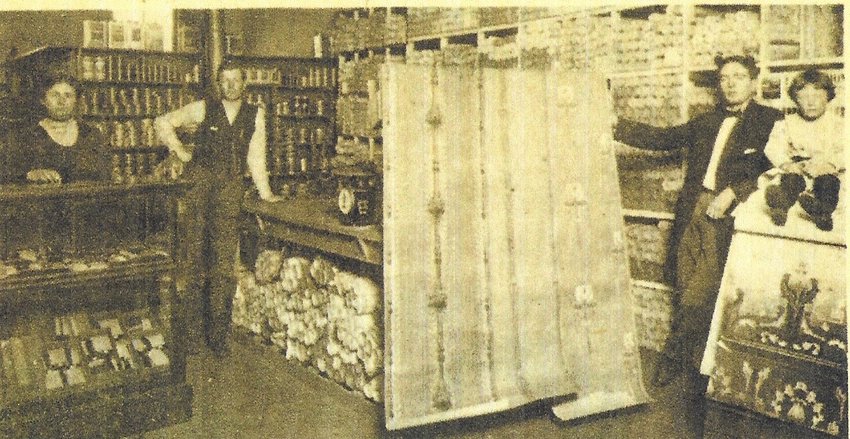 Interior view of A.O. Wheeler Wallpaper and Paint Store in Frontenac. To the left are Mr. and Mrs. Wheeler. To the extreme right is their son, Lawrence, at the age of three.