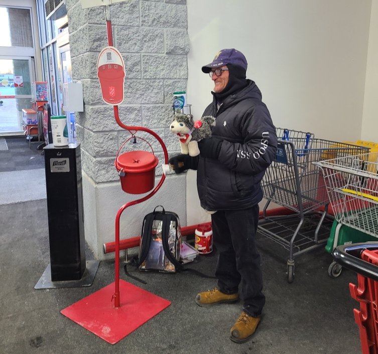Daniel Perry, a Salvation Army bell-ringer for the last 14 years, mans the red kettle at Ron's Supermarket on Friday afternoon.