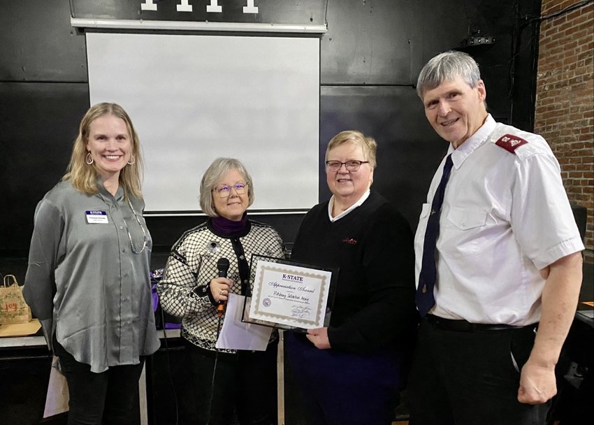 From left, Wildcat District Director Frances Graves and District Chair Kim Rutter present the Wildcat District 2022 Friend of Extension Award to Pittsburg Salvation Army representatives Majors Pat and Eric Johnson.