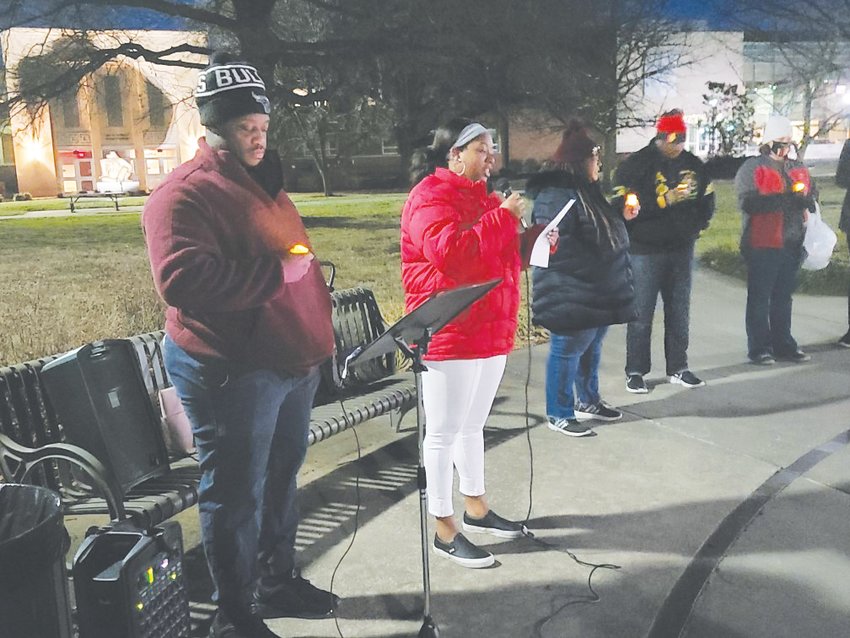 Pittsburg State University student Jourdan Bridgette, left, reads &ldquo;Letter From Birmingham Jail&rdquo; during the candlelight vigil for Martin Luther King Jr. on Monday, Jan. 17, 2022 at The Oval on PSU&rsquo;s campus.