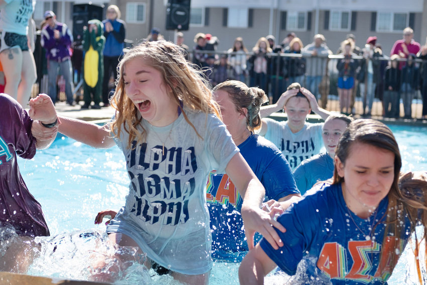 PSU students tread through cold water after leaping in for the Special Olympics Kansas Polar Plunge fundraiser in early 2020.