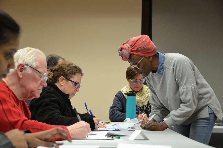 Lucy Mwanzia, right, shows attendees techniques during her free Modern Calligraphy for Beginners class at the Pittsburg Public Library on Wednesday, Jan. 25.