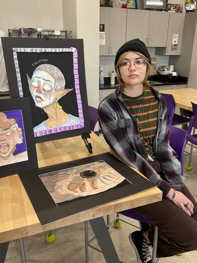 Pittsburg High School senior McKenzie Rowe sits next to her pieces that allowed her to win a $76,000 merit scholarship for the School of Art Institute of Chicago.