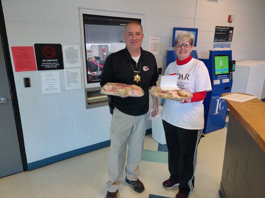 Mary Gilpin of the Oceanus Hopkins Chapter of the Daughters of the American Revolution in Pittsburg delivers trays of Valentine&rsquo;s Day cookies to Crawford County Sheriff Danny Smith. Gilpin and other members of the DAR also delivered cookies to the Pittsburg fire and police departments as a thank you for all they do.&nbsp;