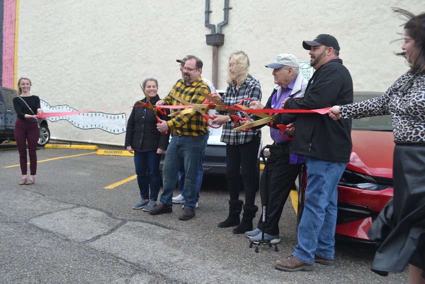 Kelly Burgess, Dr. Jim Triplett, Vonnie Corsini, and members of the Pittsburg Sustainability Advisory Committee cut the ribbon to officially open the city&rsquo;s first fast-charging station for electric vehicles.
