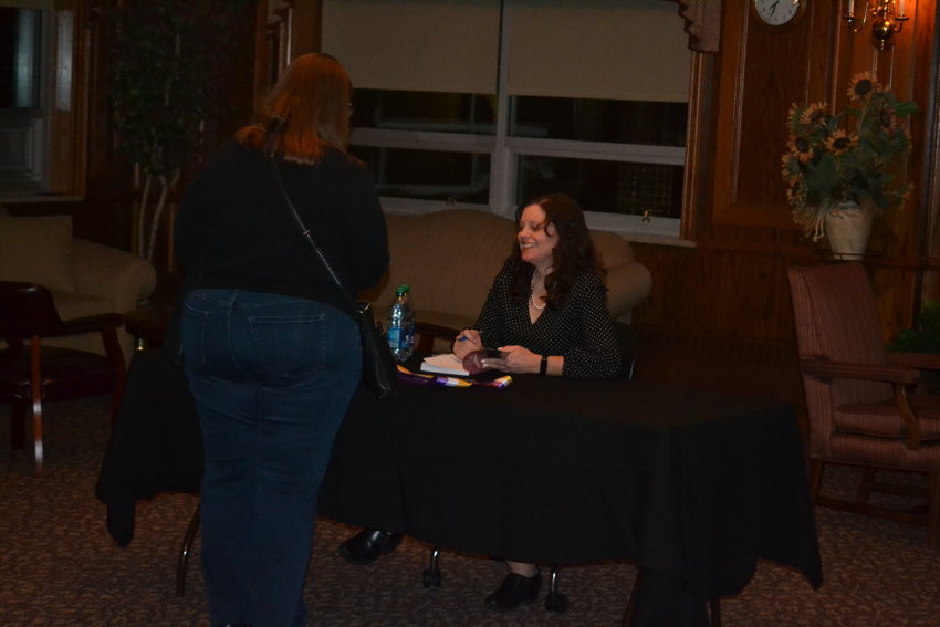 Author April Young Bennett signs a copy of her book for guests at Pittsburg State&rsquo;s Overman Student Center. Bennett appeared at the Governor&rsquo;s Room to present a history of the suffrage movement and how to apply its lessons today.&nbsp;