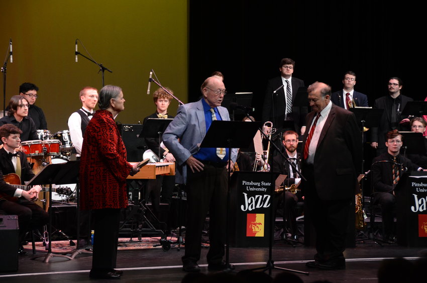 Dr. Russell Jones, middle, presents PSU Professor of Music Robert Kehle, right, with a plaque recognizing his dedication to organizing the annual Jazz Festival on Friday, March 3 at the Memorial Auditorium.